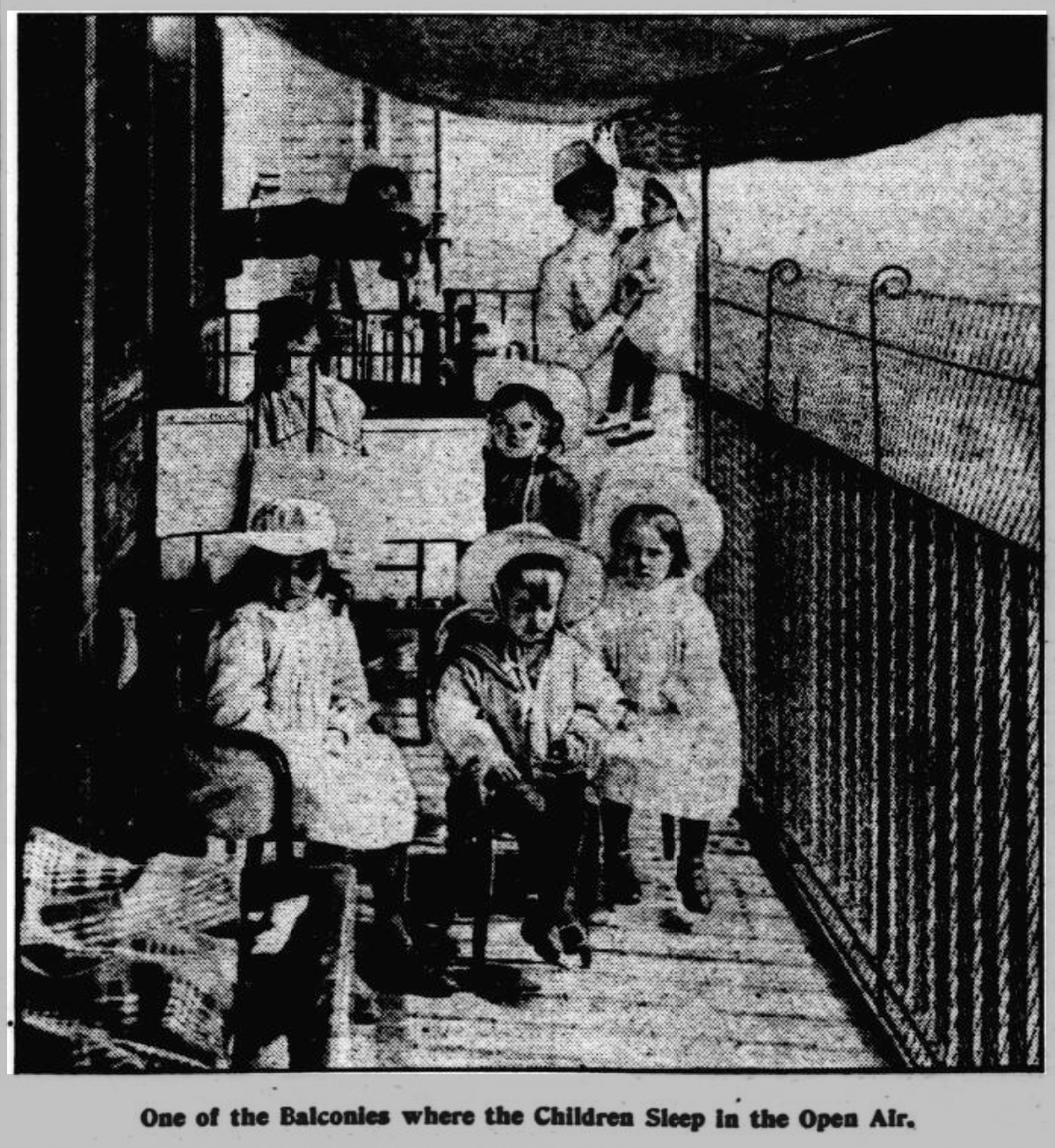 Children receiving open-air treatment on a hospital balcony