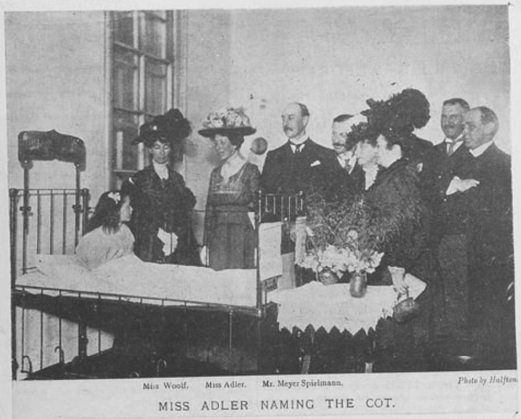 Miss Adler naming the Jewish World Cot